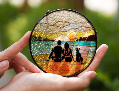 couple and dog at beach sunrise suncatcher in hands