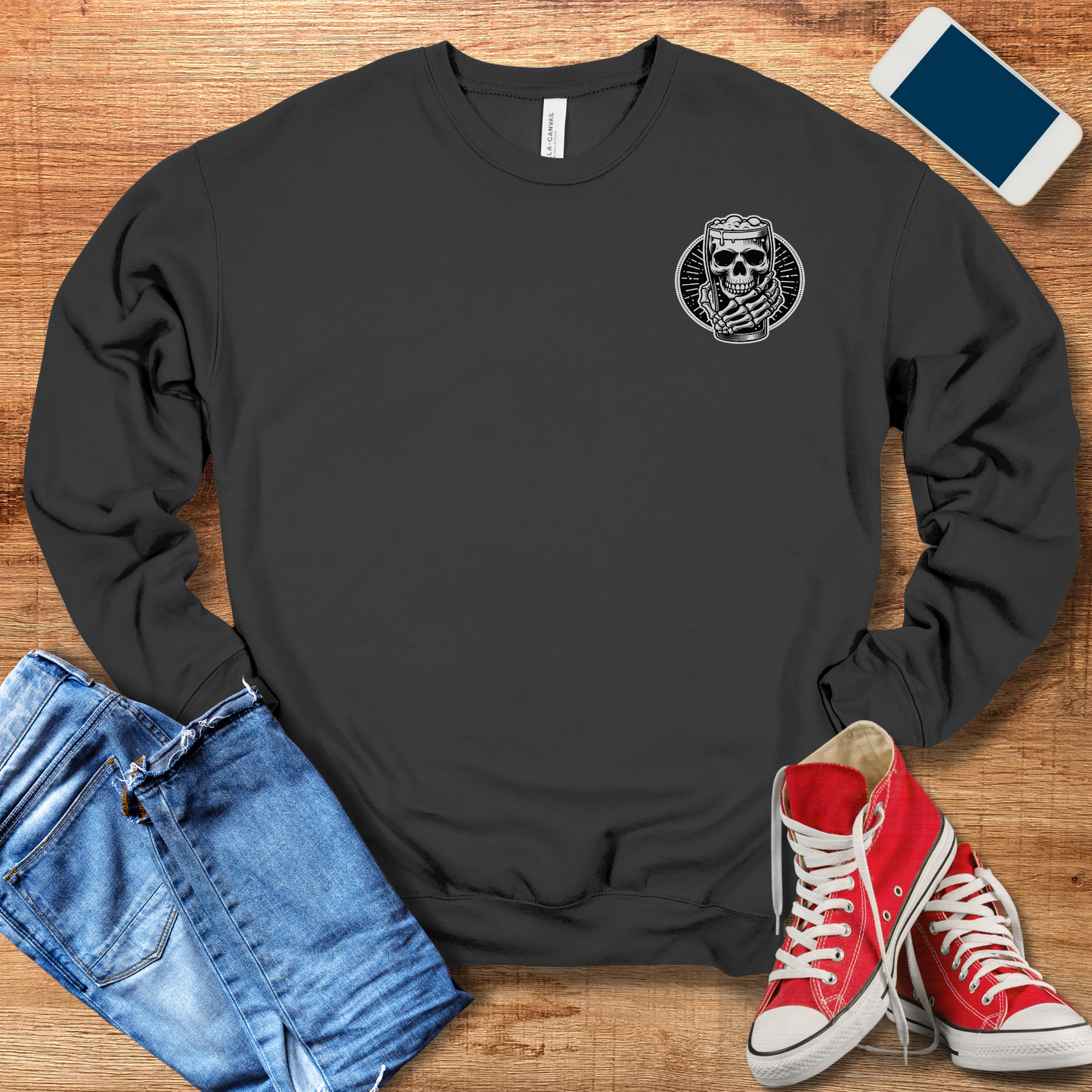 skeleton hand holding beer pocket design on front of dark grey colored crewneck sweatshirt