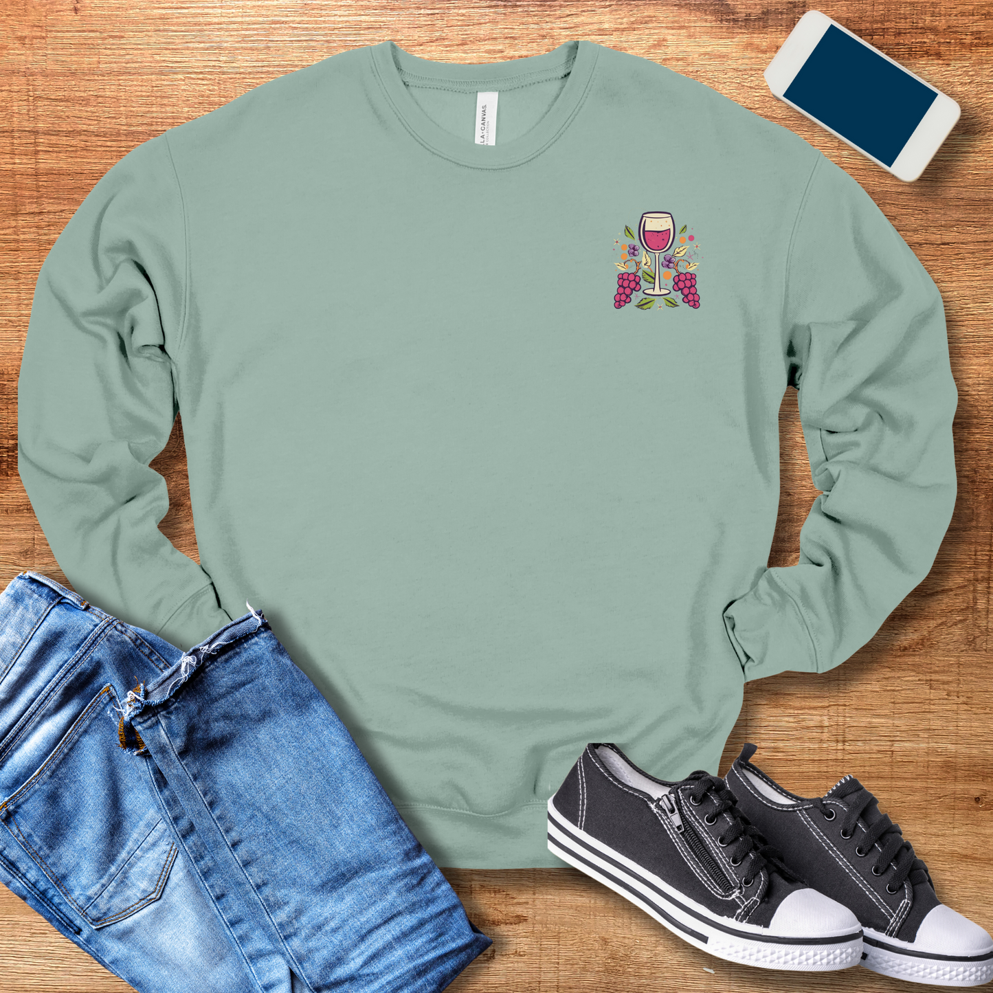 front pocket design of wine glass on dusty blue colored sweatshirt