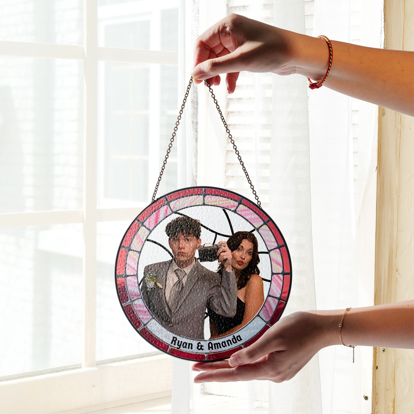 personalized photo suncatcher hanging in front of window
