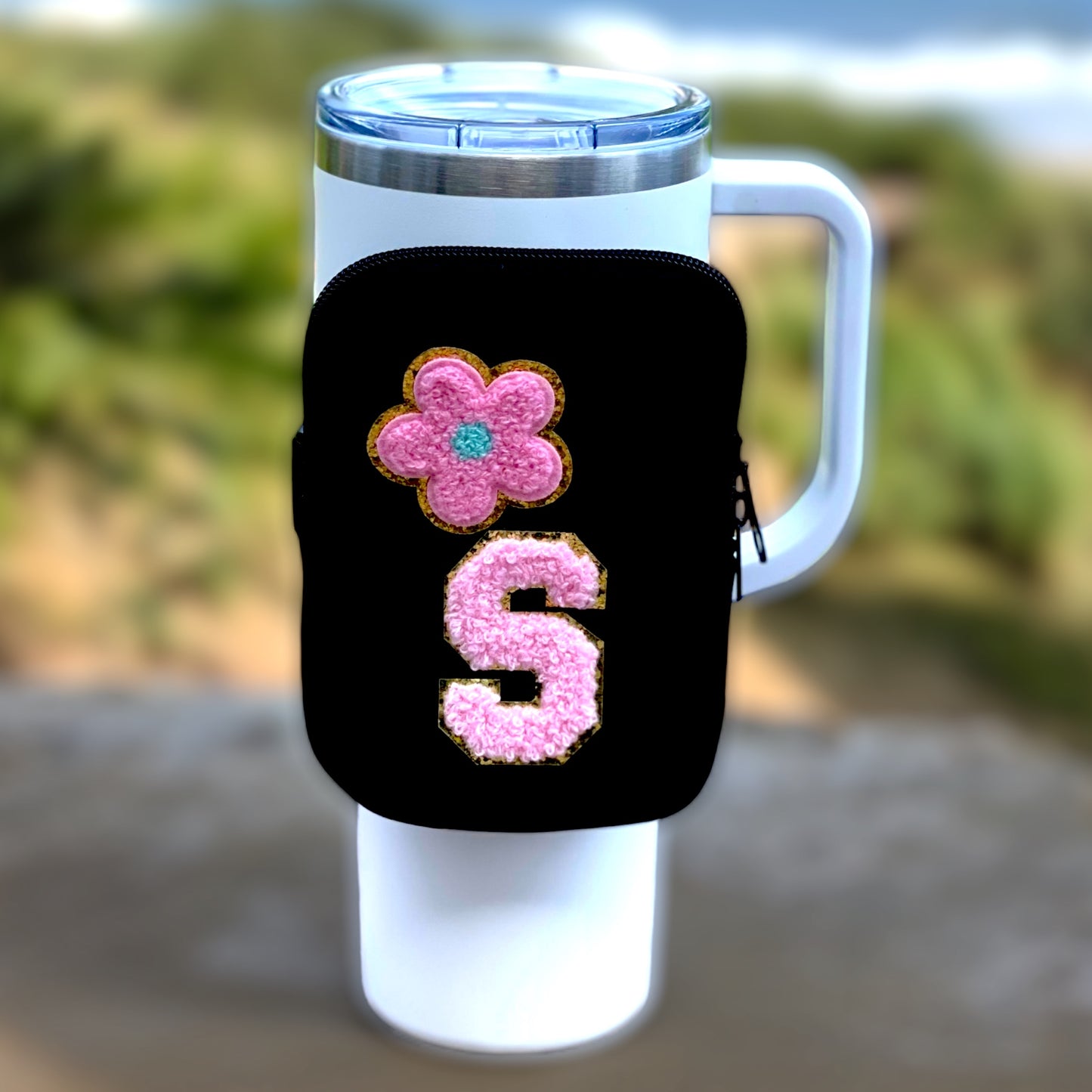 black tumbler pouch with pink chenille letter and pink flower