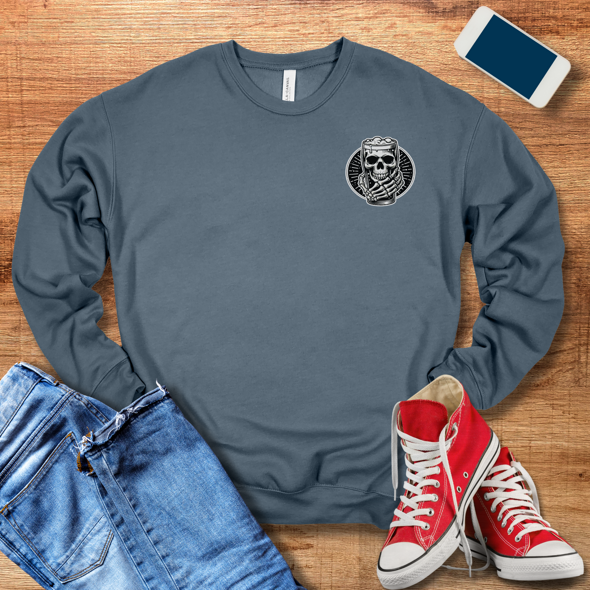 skeleton hand holding beer pocket design on front of heather slated colored crewneck sweatshirt