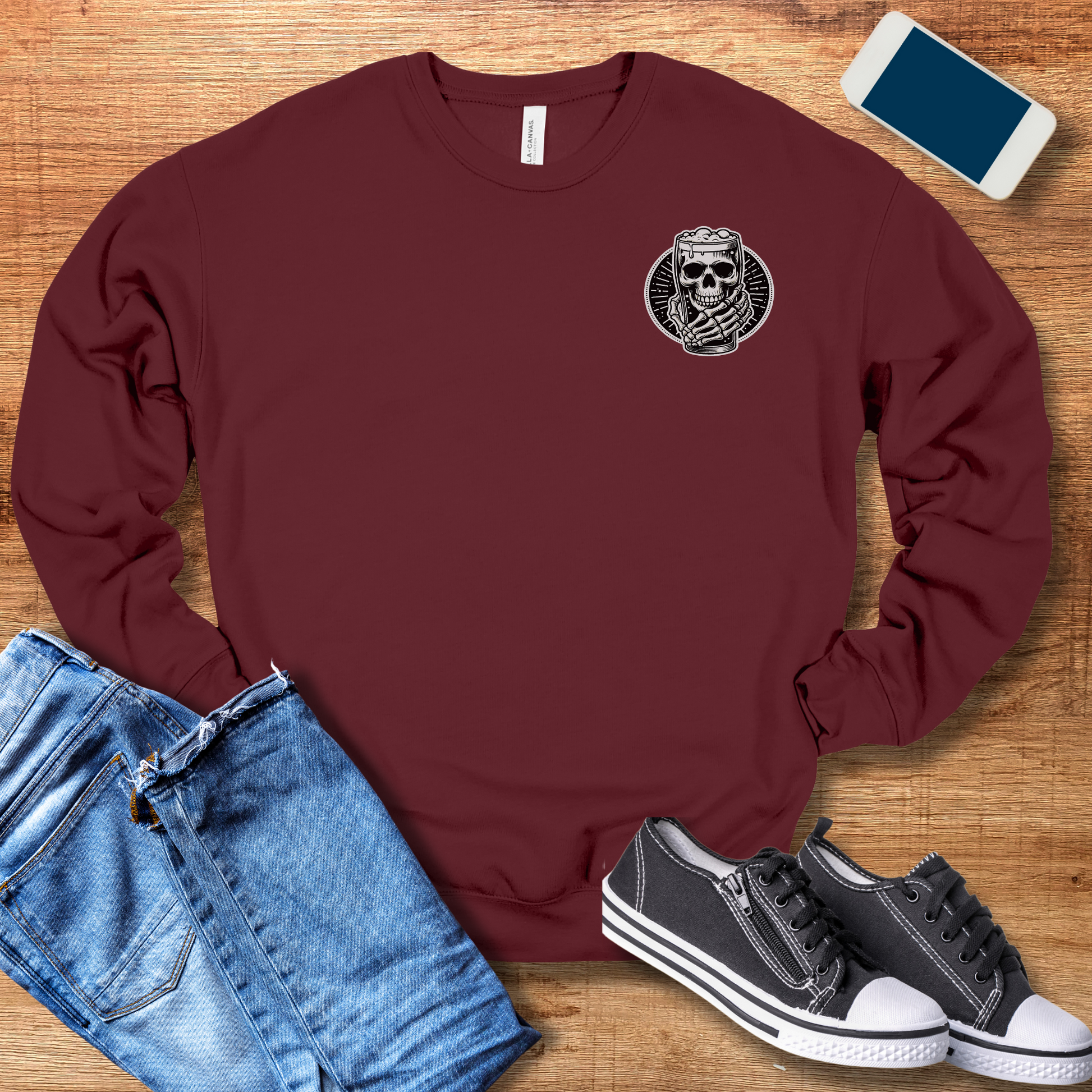 skeleton hand holding beer on front of maroon colored crewneck sweatshirt