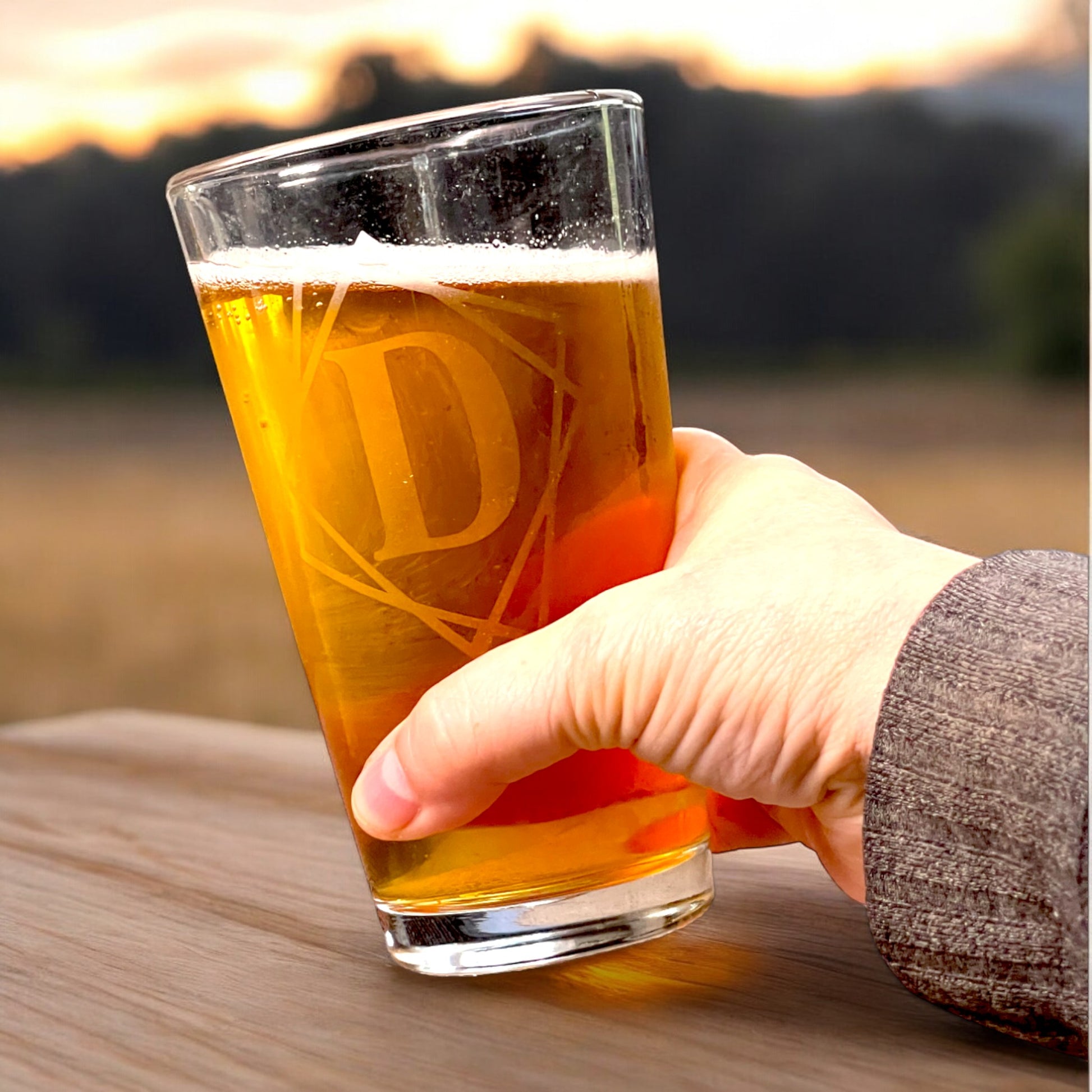 hand holding personalized pint glass with framed initial